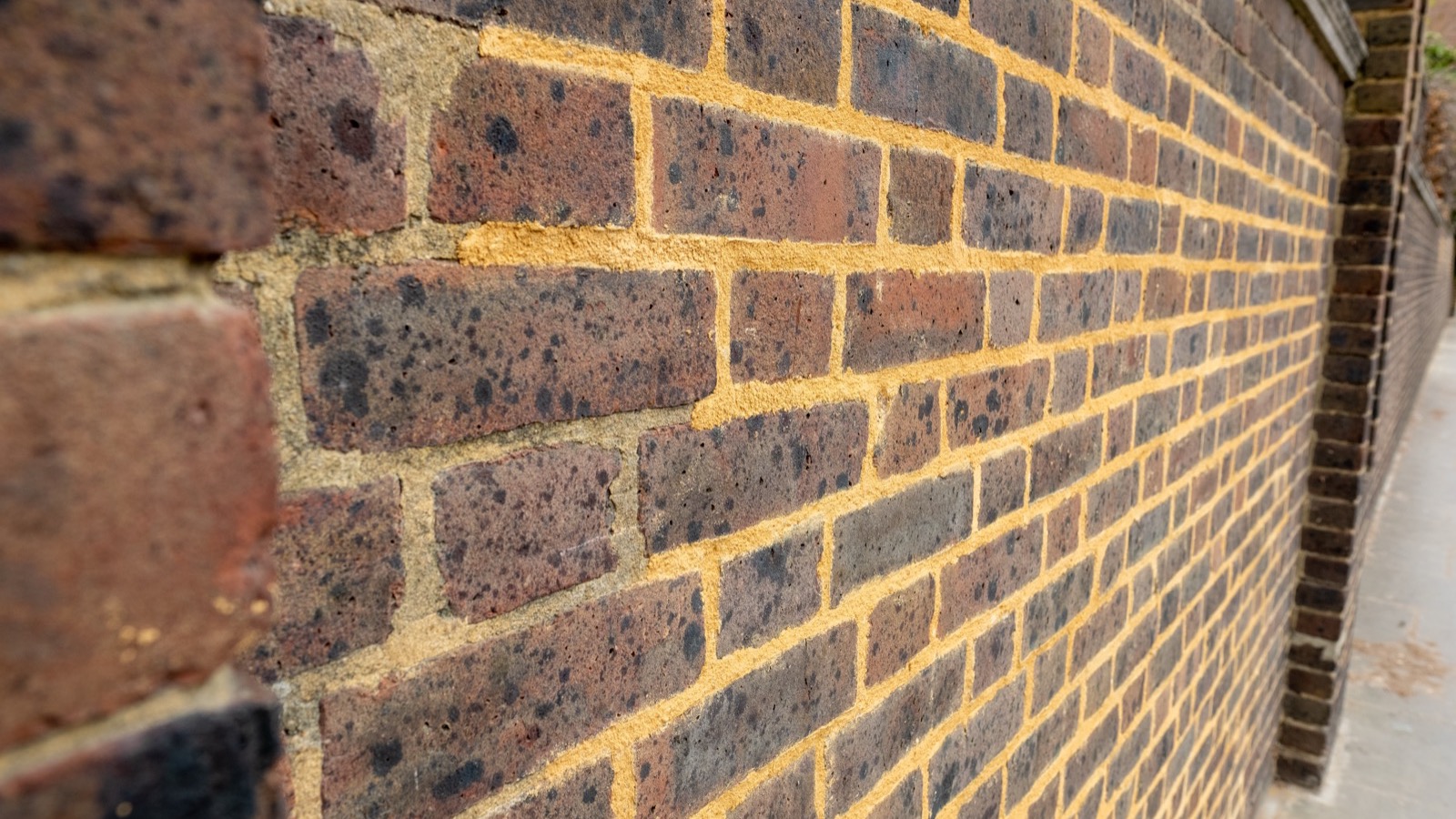 Brick repointing in progress on a Baltimore rowhouse facade