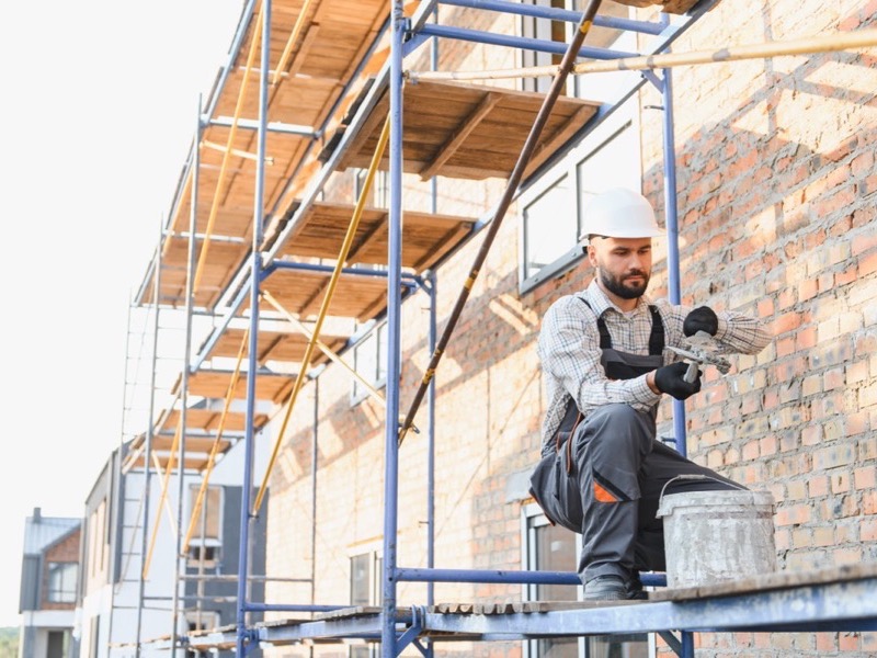 Brick repointing in progress on a Baltimore rowhouse showing old and new mortar joints