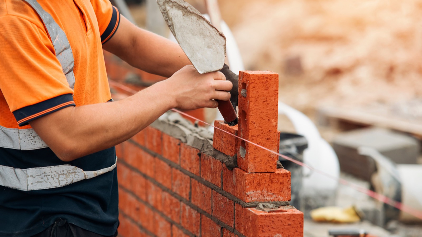 Charm City Masonry crew repointing brickwork on a Baltimore rowhouse