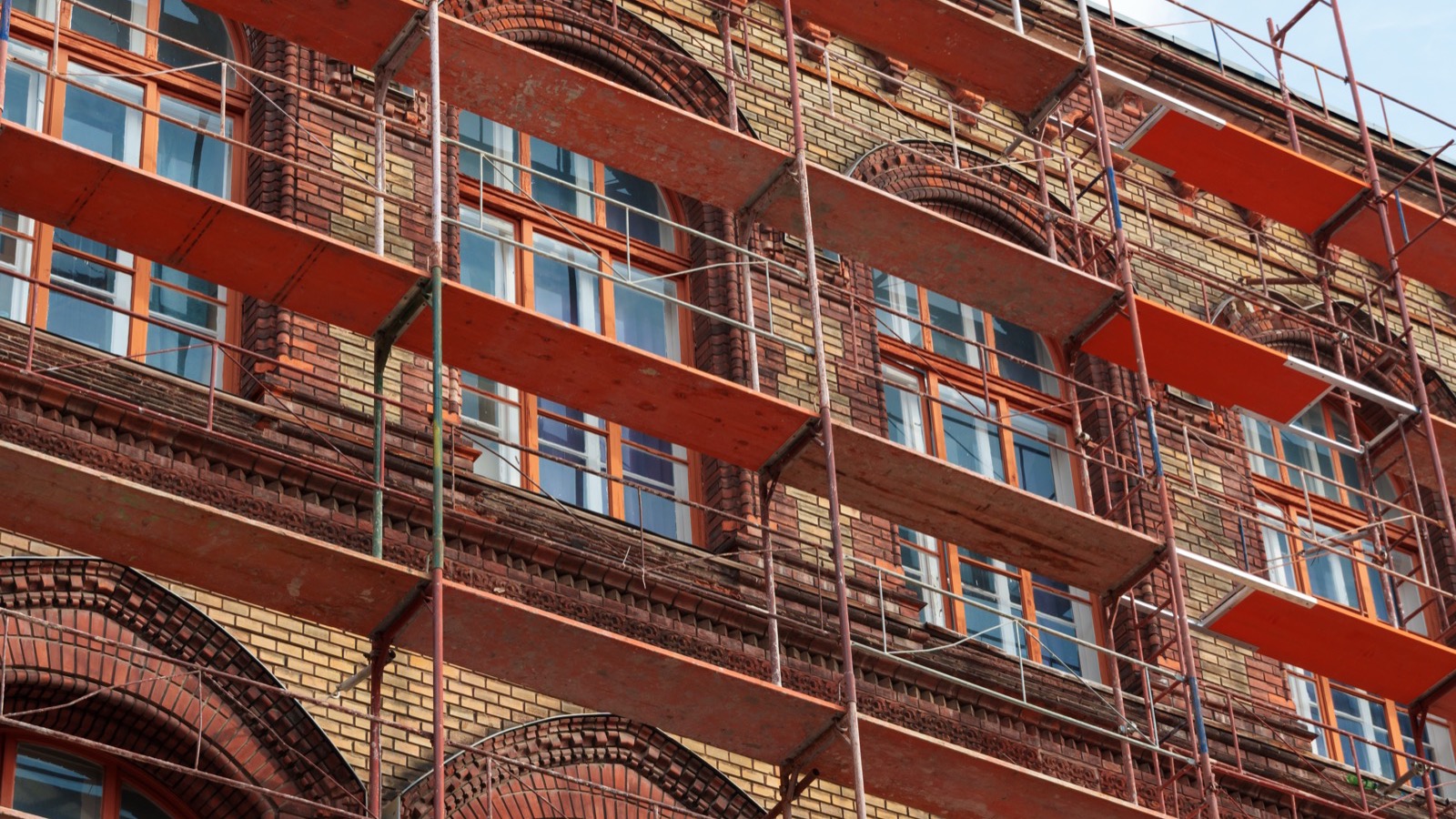 Commercial masonry contractors repointing a brick building facade in Baltimore, MD