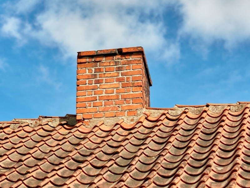 Rebuilt brick chimney above the roofline on a Baltimore home