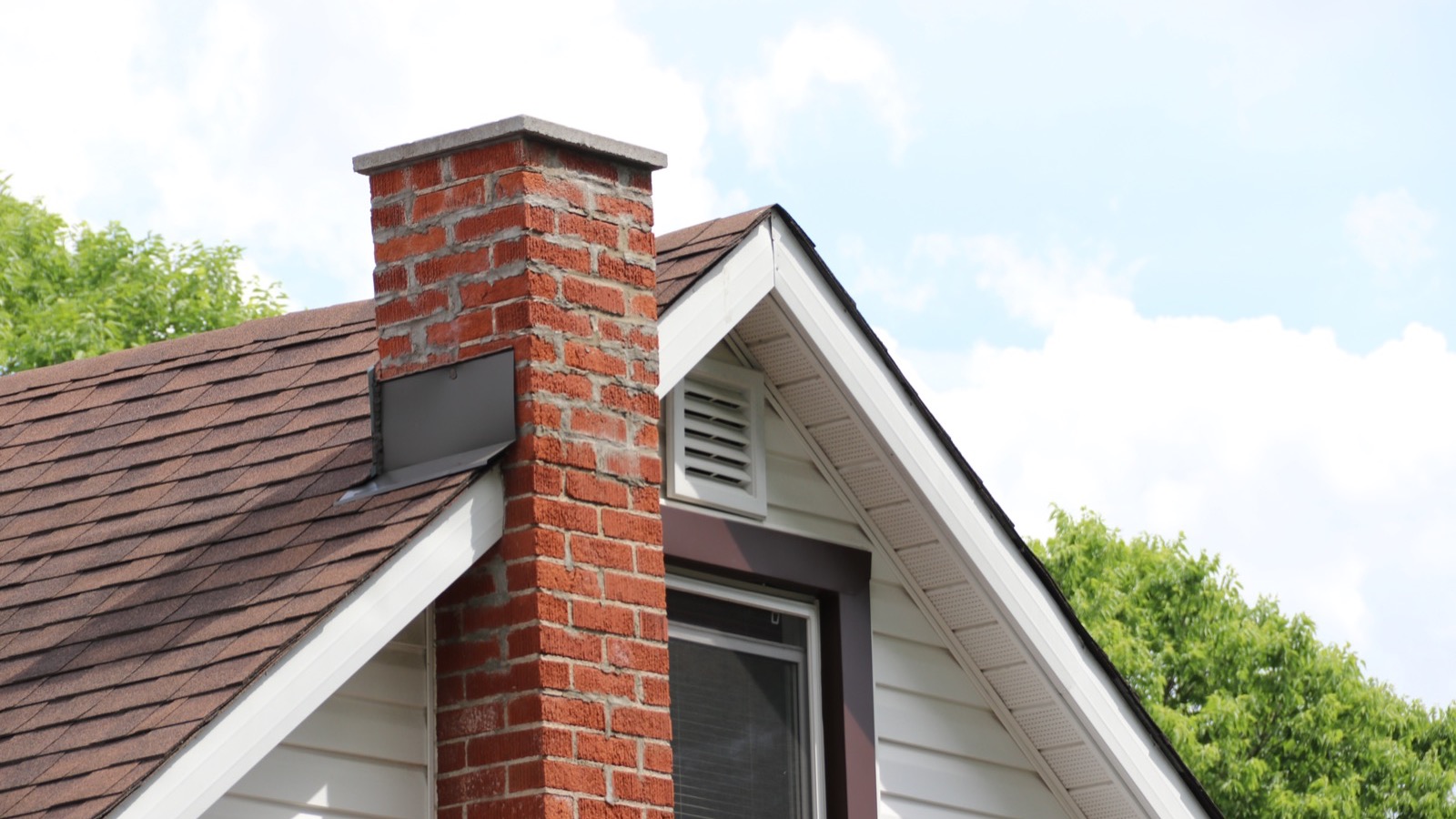 Rebuilt brick chimney with a new cast crown and stainless cap in Baltimore, MD