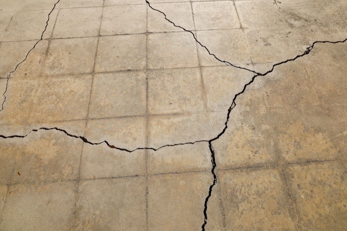 Salt-damaged concrete step showing surface spalling