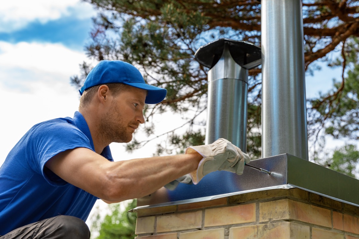 Stainless steel chimney cap installed over a clay flue tile